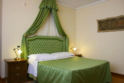 Ένα ή περισσότερα κρεβάτια σε δωμάτιο στο Villa Cappuccini