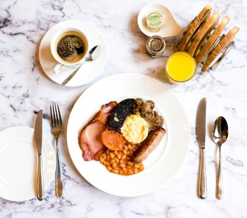 a white plate of breakfast food on a table at The Jubilee Hotel in Nottingham