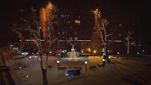a city at night with a christmas tree and lights at Medical and Spa Centre Merkur in Vrnjačka Banja