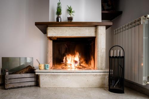 a fireplace in a living room with a fire in it at LaVistaDeiSogni Muranuove in Celano
