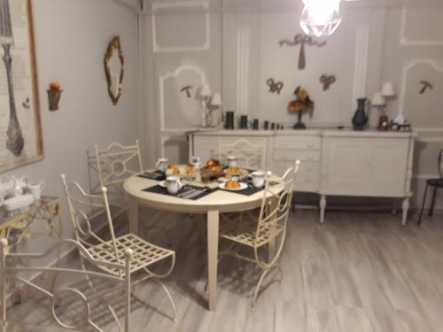 a dining room with a table and chairs and a table and chairsktop at LA MONGEARDIERE in Ay