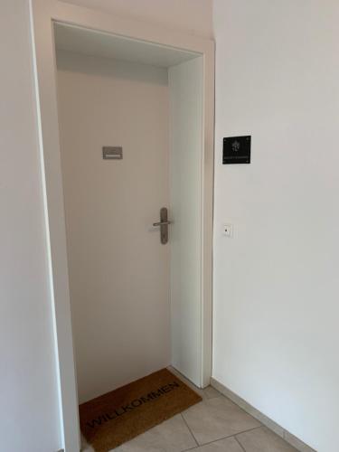 a hallway with a door with a sign on it at Ferienwohnung Konzept Schmiede in Seeboden