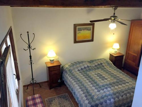 a bedroom with a bed and two lamps on tables at Il Fienile in San Gimignano