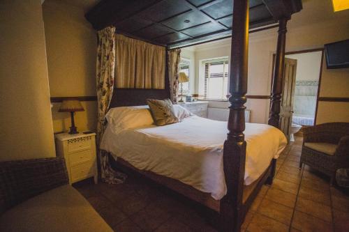a bedroom with a canopy bed in a room at Domvilles Farm self catering Courtyard Stable in Alsager