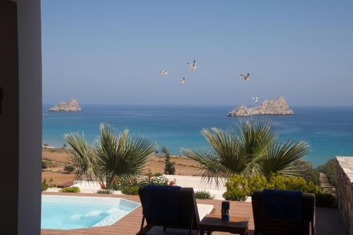 a view of the ocean from the balcony of a house at Krinakia Villas in Xerokampos