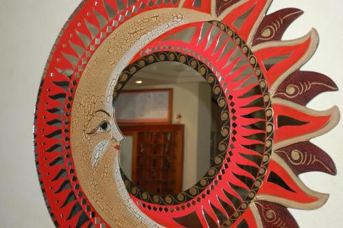a mirror with a face in the middle at Hotel Ristorante La Terrazza in Lido di Camaiore