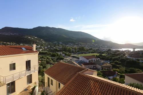 a view of a town with houses and a mountain at Ithaca's Poem Apartments in Vathi, Ithaka