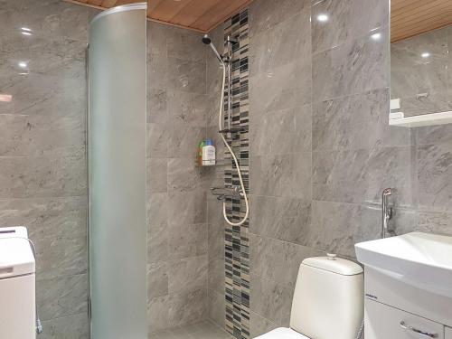 a bathroom with a shower and a toilet and a sink at Holiday Home Immelkotsa 7 e by Interhome in Levi