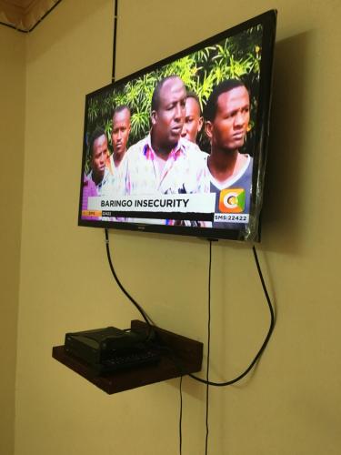 a flat screen tv hanging on a wall at Le Paradis Nyali in Mombasa