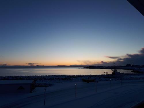 a sunset over a body of water with the ocean at Hotel Duus by Keflavik Airport in Keflavík