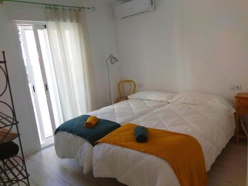 a bedroom with a bed with two o pillows on it at Abá apartamento in Almería