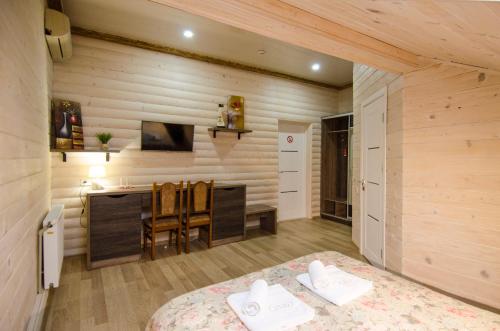 a bedroom with a bed and a desk in a room at Diamond De Luxe in Kolomyya