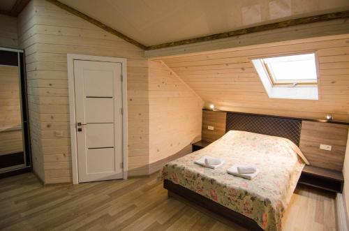 a bedroom with a bed and a window at Diamond De Luxe in Kolomyya