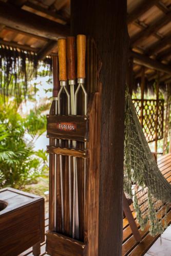 a group of wine bottles in a wooden holder at Pousada Cabanas Kaia Lua in Praia do Rosa