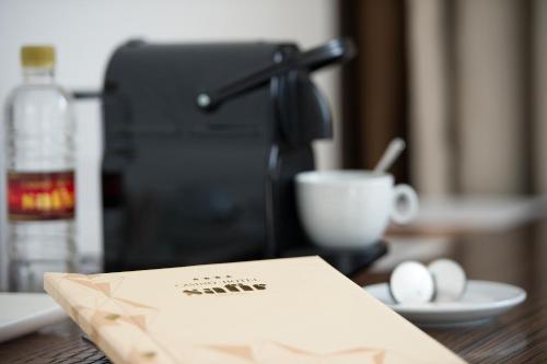 a book sitting on a table with a cup of coffee at Safir Hotel Casino in Sežana