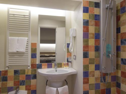a bathroom with a sink and a shower at Hotel Villa Lalla in Rimini