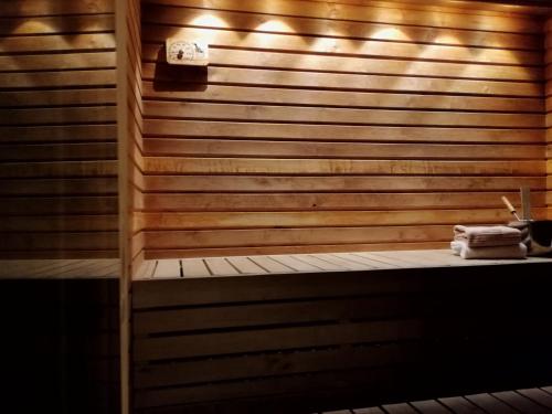 a sauna with two towels on a wooden wall at Marina Holiday Rauhan Village Apartments in Imatra