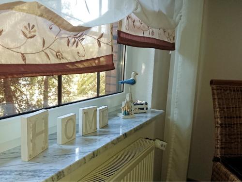 a window sill with cards on a radiator in a room at Ferienhaus Wieke in Wiesmoor