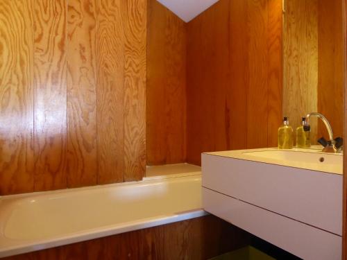 a bathroom with a bath tub and a sink at La Maison Tresallet in Les Coches