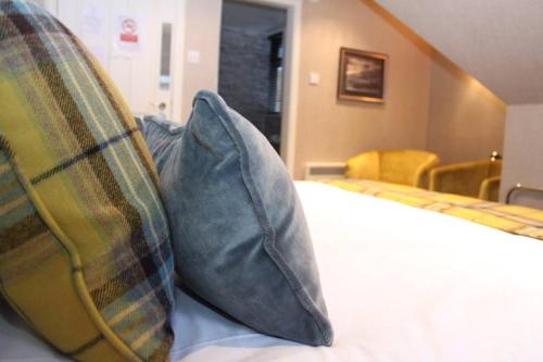 A bed or beds in a room at The Dowans Hotel of Speyside 