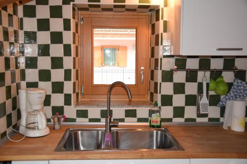 a kitchen counter with a sink and a window at Casa Chiocciola CIPAT O22138-AT-O66928 in Pelugo