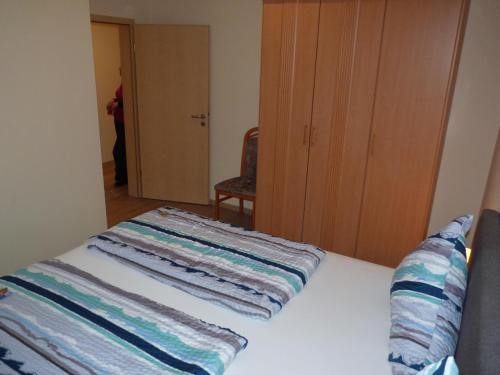a bedroom with a bed with towels on it at Cafe und Pension Blohm in Greifswald