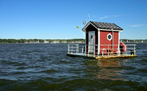 a small house on a dock in the water at Utter Inn in Västerås