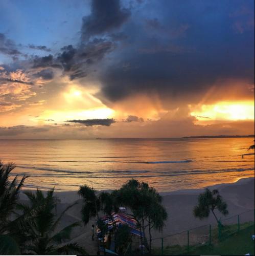a sunset on the beach with the ocean at Twenty-Two Weligambay in Weligama