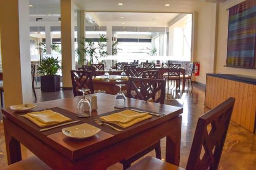 a dining room with a table and chairs in a restaurant at Twenty-Two Weligambay in Weligama