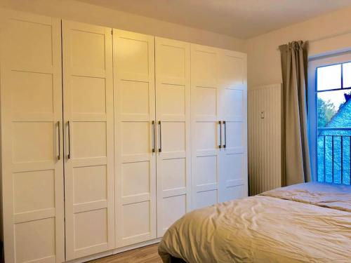 a bedroom with white cabinets and a bed at Villa am Wall in Osnabrück