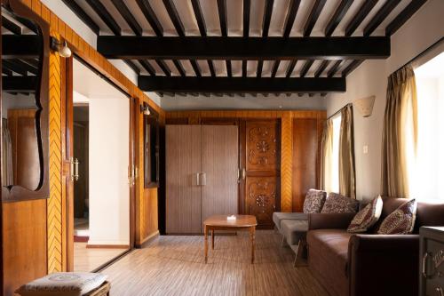 a living room with a couch and a table at Shaligram Hotel in Pātan