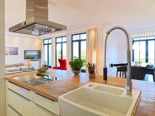 a kitchen with a sink and a counter top at Waterview Cloud***** in Ostseebad Sellin