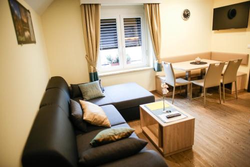 a living room with a couch and a table at Guest House Vila Moj Mir in Rateče