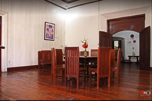 a dining room with a table and chairs at Escolta's Homey Lodge in Vigan
