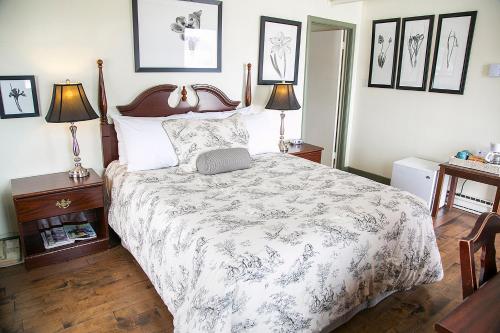 a bedroom with a large bed and two lamps at Lanes Privateer Inn in Liverpool