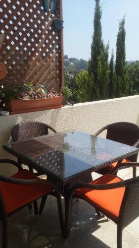 a black table and chairs on a patio at Pelagos Hill Apartment in Paphos City