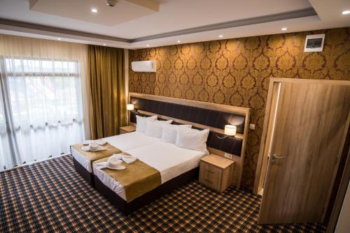 a hotel room with a large bed and a window at SPA Kompleks Raiski Kat in Dimitrovgrad