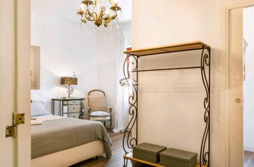a bedroom with a bed and a chandelier at Elegante & Exclusive Maison in Sorrento