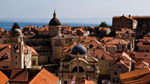 a view of a city with roofs and buildings at Sun Gardens Dubrovnik in Dubrovnik