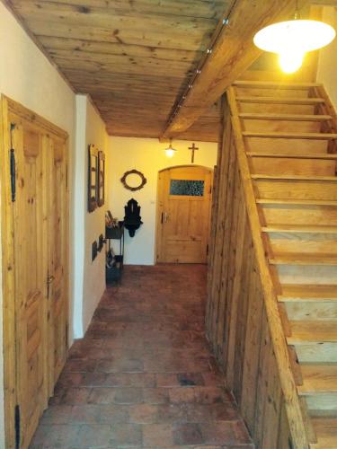 a hallway in a house with wooden ceilings and stairs at Apartmány Stará Škola in Krásná Lípa