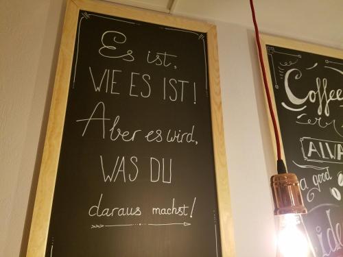 a chalkboard on a wall with a sign on it at Hotel Zur Luppbode in Treseburg
