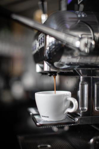 a cup of coffee is being poured into it at Hôtel du Domaine, centre de villégiature et de congrès in Thetford Mines