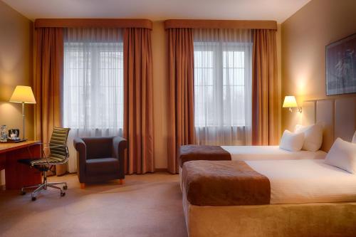 En eller flere senge i et værelse på Focus Hotel Szczecin