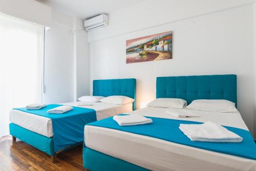 Postel nebo postele na pokoji v ubytování Super Paradise Apartments