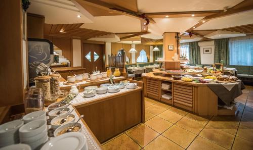 a kitchen with many plates and dishes on the counters at Vitaurina Royal Hotel in Molini di Tures