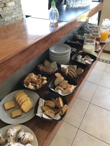 a bunch of different types of bread and pastries at Hostal del Sol in San Bernardo