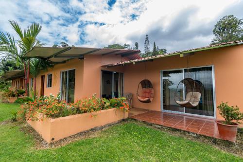 a house with a garden in front of it at Hotel Nepenthe B&B in El Castillo de La Fortuna