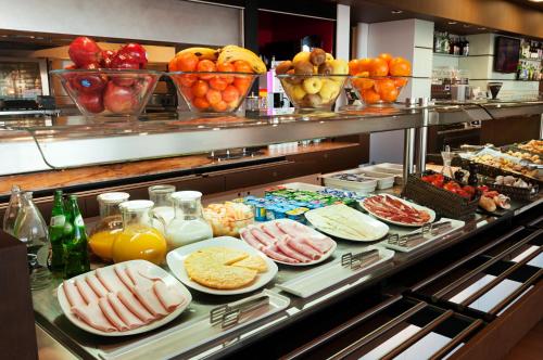 a buffet line with different types of food on plates at Ibis Lleida in Lleida