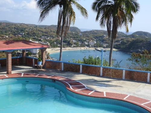 a swimming pool with a view of a body of water at Angel del Mar in Puerto Ángel
