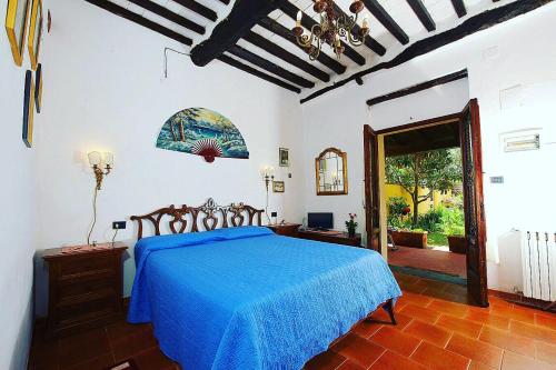 a bedroom with a bed with a blue bedspread at Agriturismo La Conte in Lucca